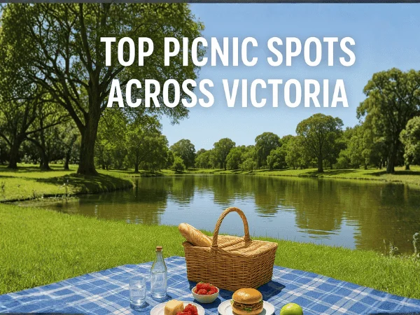 Picnic-setup-by-lake-in-Victoria-with-wicker-basket-food-and-green-trees