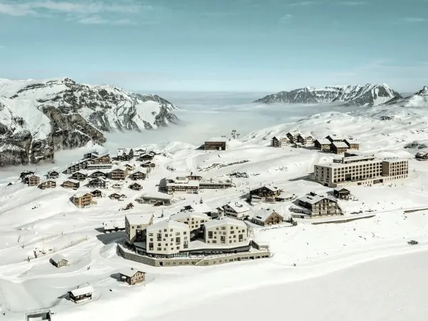Aerial view of a Swiss alpine village blanketed in snow during winter