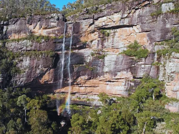 Side view of Dandongadale Falls highlighting the cliff and surrounding forest in Victoria