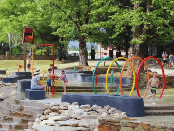 Ovens River flowing through Bright River Reserve, Bright with footbridge, trees, and picnic areas