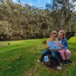 Children reading an activity book along the Jamieson Paw Prints Walk in Jamieson, Victoria
