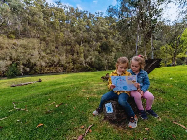 Children reading an activity book along the Jamieson Paw Prints Walk in Jamieson, Victoria