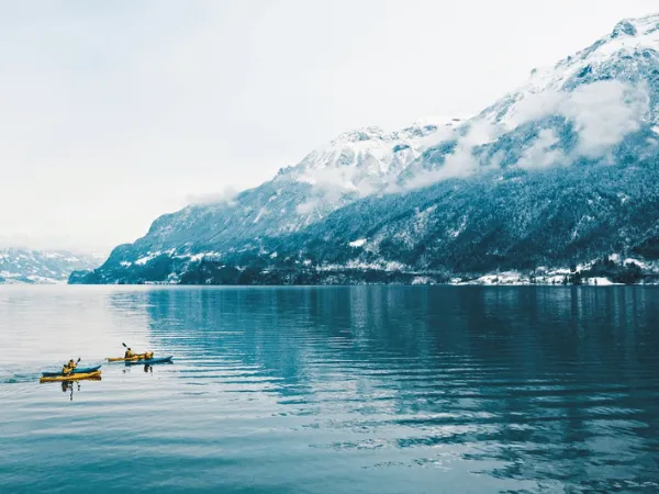 Lake Brienz winter scenery with turquoise water and snow covered mountains