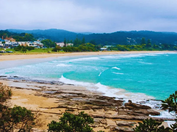 Panoramic view of Lorne Foreshore beach with golden sand and calm waves along the Great Ocean Road