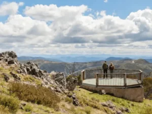 Visitors enjoying panoramic alpine views from Mt Higgi Lookout at Mount Hotham in Victoria