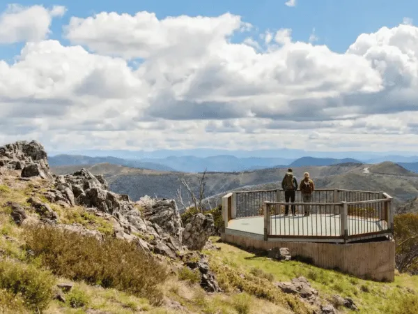 Visitors enjoying panoramic alpine views from Mt Higgi Lookout at Mount Hotham in Victoria
