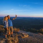 Couple taking photos at Mt Pilot Lookout with panoramic views across Victoria