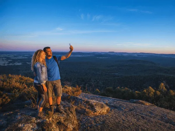 Couple taking photos at Mt Pilot Lookout with panoramic views across Victoria