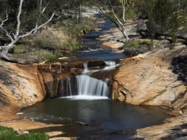 Natural rock pool and waterfall along Spring Creek in Beechworth Gorge