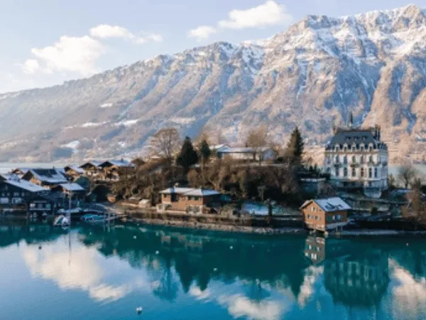 Snowy mountains reflecting in Lake Brienz during winter