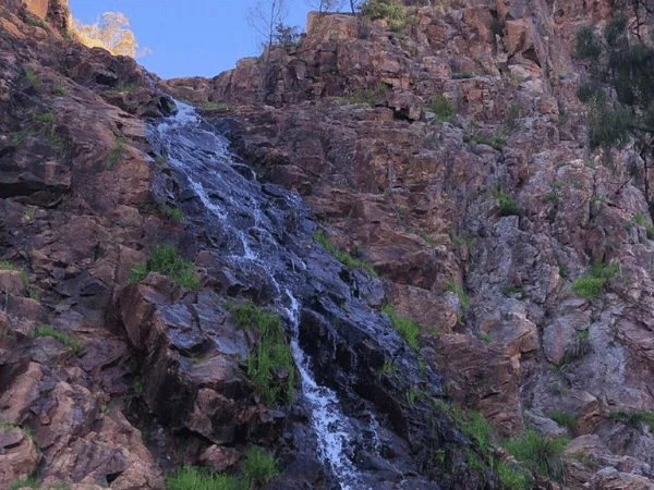 Detailed zoom-in image showing water flowing over the rocky steps of Jubilee Falls in Daylesford.