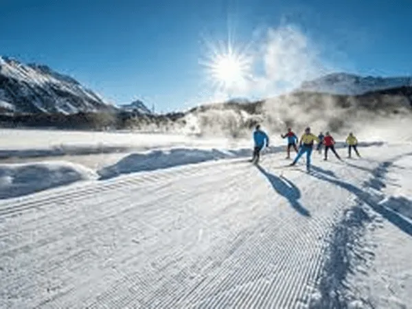 Cross-country skiers enjoying snowy trails in Celerina Engadin Valley