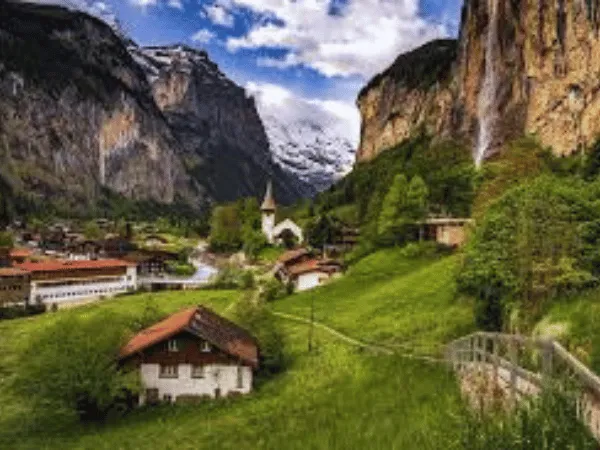 Lauterbrunnen Valley Switzerland with lush green meadows, towering cliffs, and cascading waterfalls