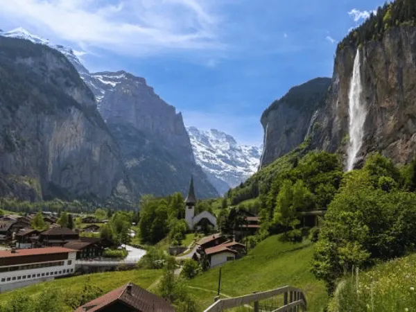 Lauterbrunnen Valley Switzerland with lush green meadows, towering cliffs, and cascading waterfalls 1