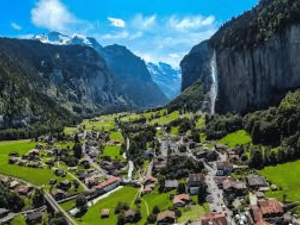 Lauterbrunnen Valley Switzerland with lush green meadows, towering cliffs, and cascading waterfalls 3