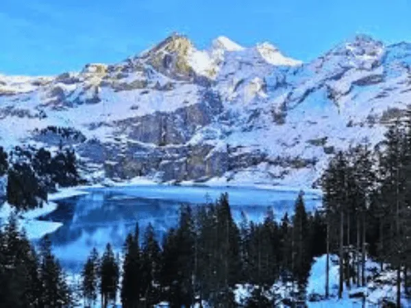 Oeschinensee Switzerland with turquoise alpine lake surrounded by mountains near Kandersteg