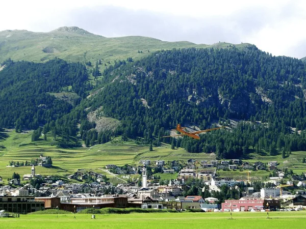 Green valley landscape surrounding Samedan in the Engadin region of Switzerland
