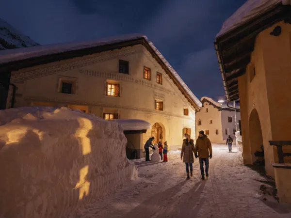 Traditional Engadin houses in Bever Switzerland lit up at night