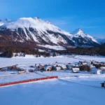 Snow-covered Celerina village with mountains in the Engadin Valley during winter