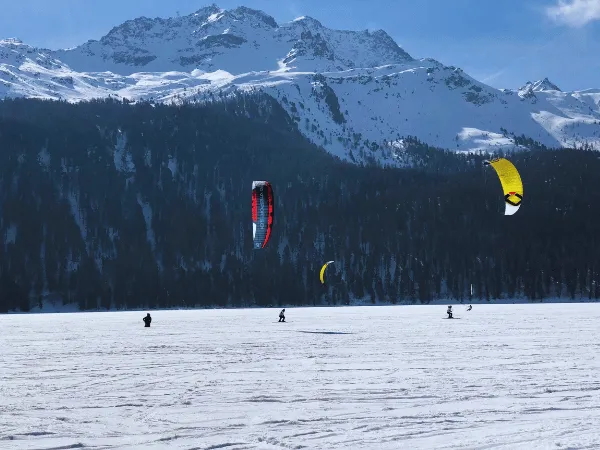 Snowkiting and winter sports on frozen Silvaplana lake in Graubünden
