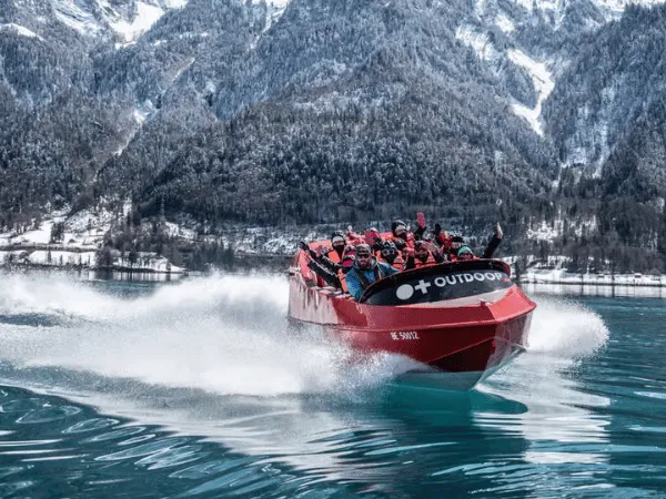 Winter boat cruise on Lake Brienz surrounded by snow covered mountains