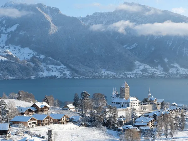 Winter view of Lake Brienz with surrounding Swiss Alps and lakeside village