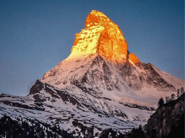 Golden alpenglow on the Matterhorn at sunrise during winter