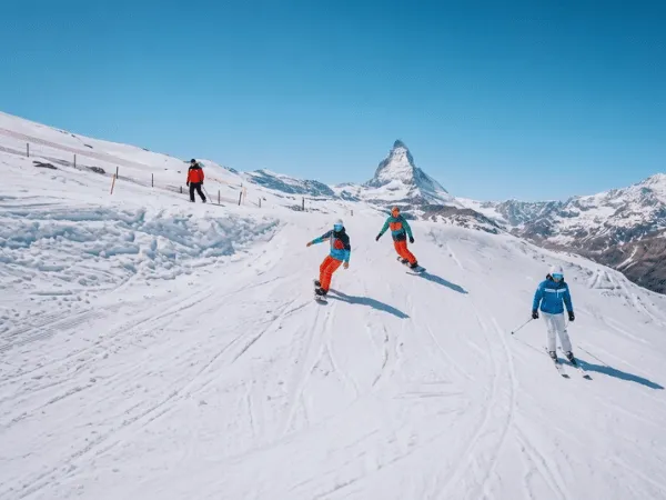 Skiers enjoying winter slopes with the Matterhorn in Zermatt, Switzerland