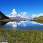Matterhorn mountain reflected in a calm alpine lake near Zermatt Switzerland on a clear summer day