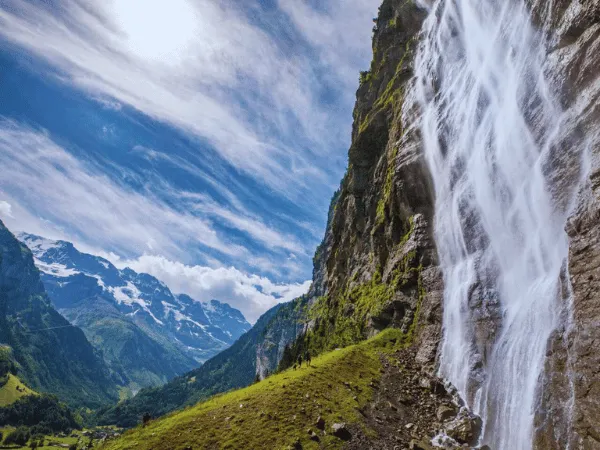 scenic landscape of lauterbrunnen valley surrounded by alpine cliffs and waterfalls in switzerland
