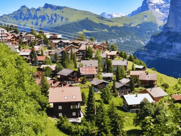 cliffside village of mürren switzerland with wooden chalets and green slopes in summer