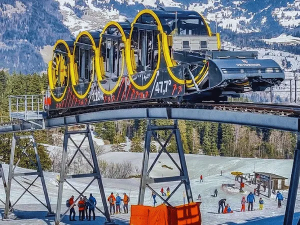 stoosbahn station with snow covered mountains in switzerland