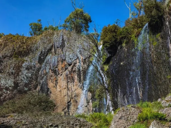 Carmichael Falls flowing over rocky cliffs in Victoria.