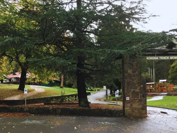 Stone entrance gate to Kokoda Track Memorial Walk on a rainy autumn day