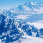 lessexplore-himalayan-mountain-peaks-above-clouds