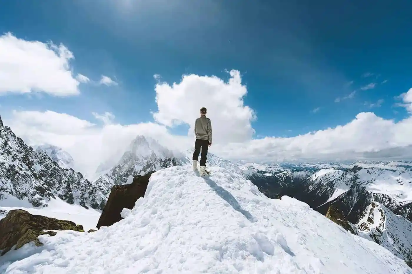 lessexplore-solo-climber-snowy-mountain-summit