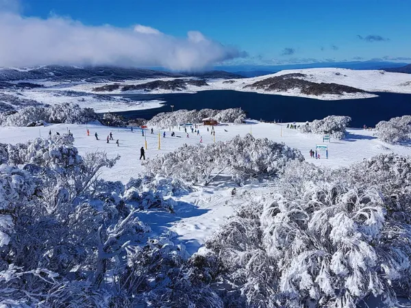 Aerial view of skiers near Rocky Valley Storage at Falls Creek covered in fresh snow