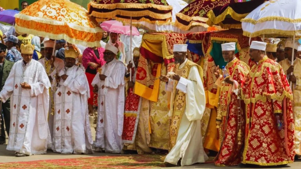 Ethiopian Orthodox priests in gold and red robes at religious festival