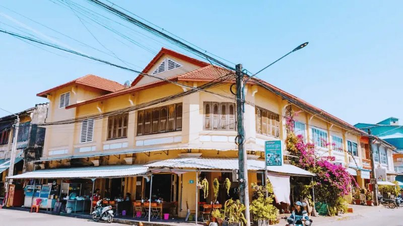 French colonial building with a café on a Kampot street corner