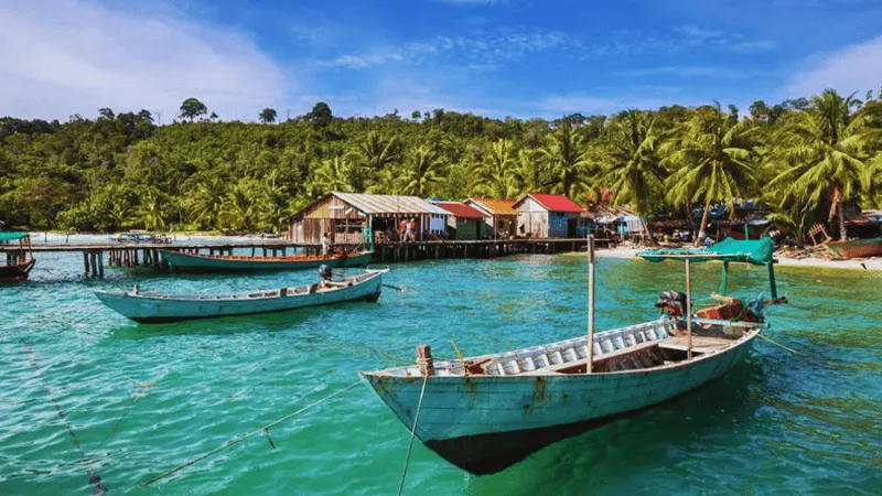 Traditional fishing boats docked at a coastal village near Kampot