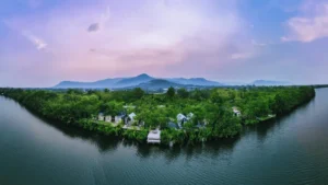 Aerial view of a riverside resort surrounded by trees in Kampot