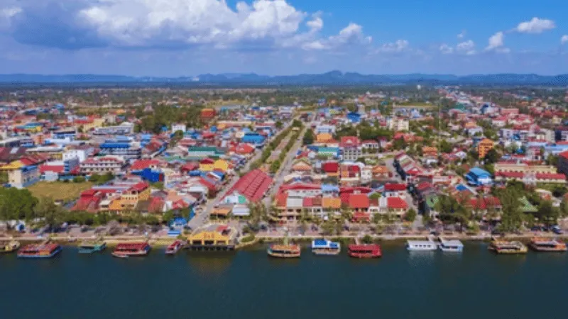 Aerial view of Kampot town center and boats along the riverfront