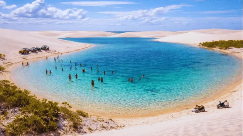 People swimming in a blue lagoon at Lençóis Maranhenses National Park