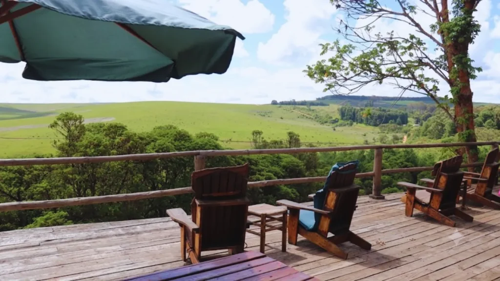 Wooden deck with chairs overlooking green valley at Nyika Plateau