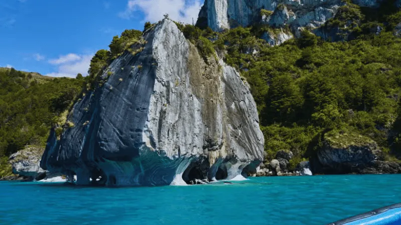 Marble Cathedral Chile rock formation with boat on turquoise lake