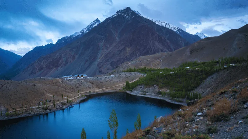 Peaceful mountain lake in Phander Valley with rugged peaks
