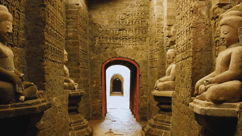 Buddha statues inside an ancient Mrauk U temple passageway