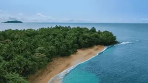 Aerial view of forested coastline and turquoise ocean in Sao Tomé