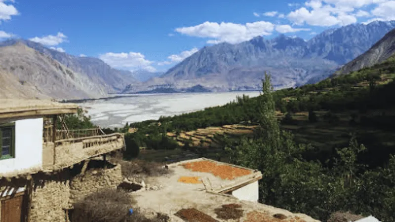 Traditional village surrounded by mountains in Phander Valley