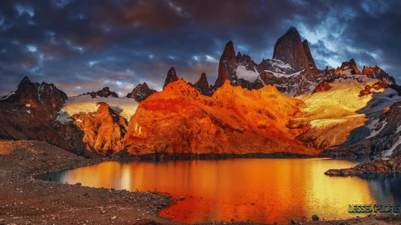 Fitz Roy sunrise glow over Patagonian mountains and lake